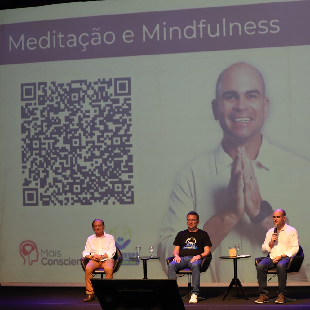 Felipe Lapa no palco do SIMESPE, diante do telão “Meditação e Mindfulness”