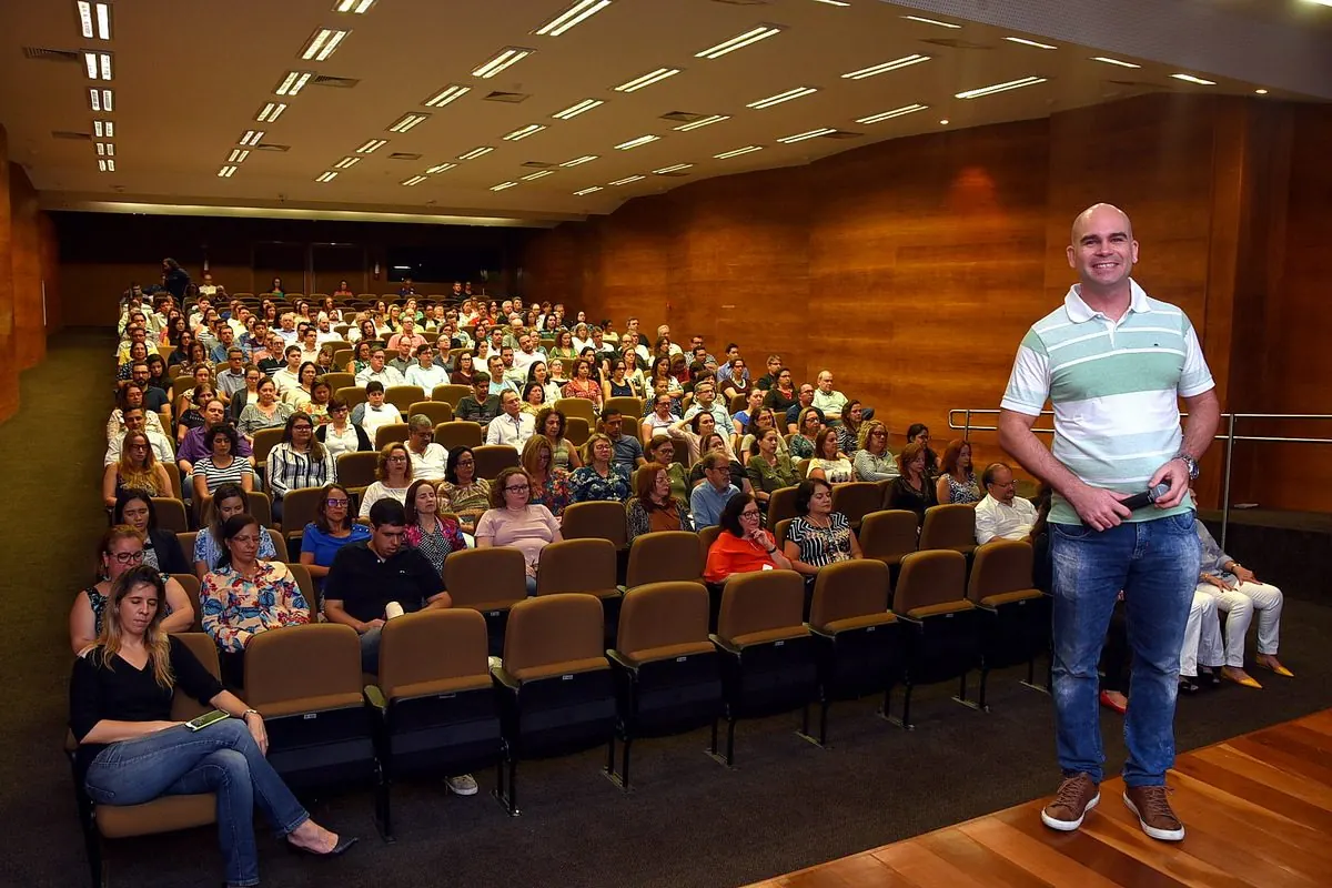 Felipe Lapa diante de um auditório cheio de servidores